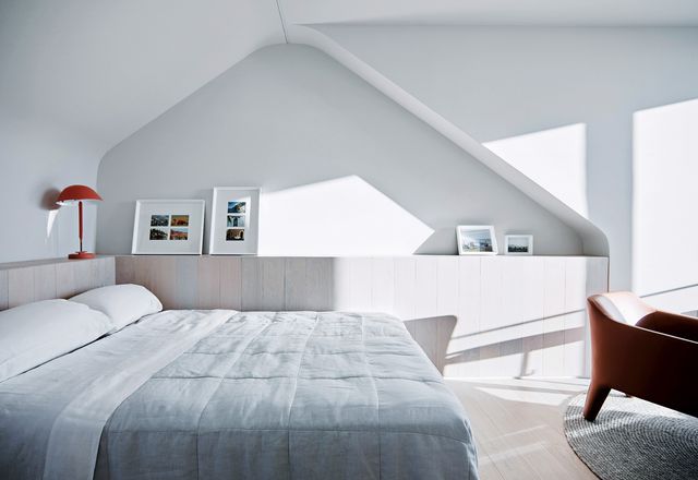 A recessed niche in the bedroom wall makes reference to the form of the original attic space.
