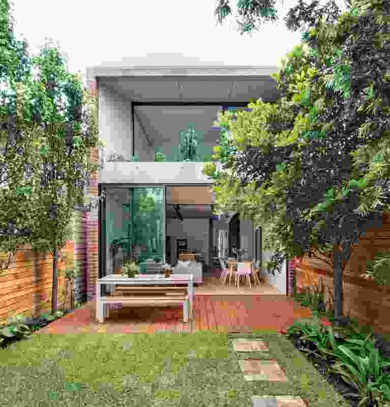 The rear addition is constructed from expressed off-form concrete and reaches into the garden.
