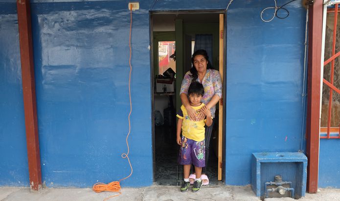 Edi, one of Quinta Monroy's residents, with one of her children.