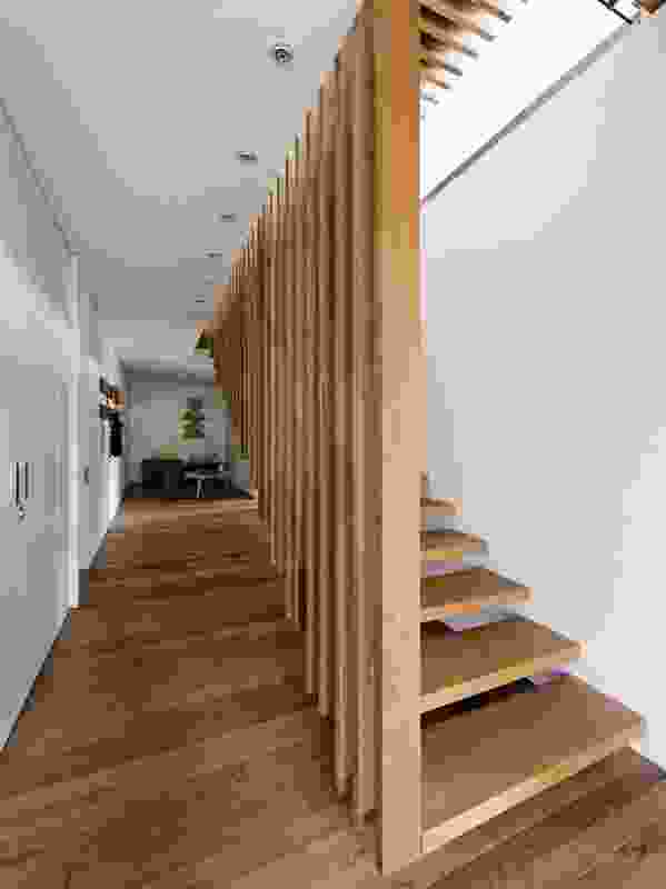 A double volume, timber screen wall leads down to the lower level.
