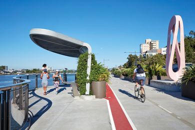 Lush subtropical plantings frame the Riverwalk’s edge, separating cyclists from vehicular traffic and softening the architectural forms of the shelters.