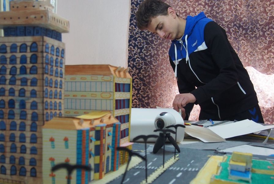Mohammed Kteish at work creating his cityscape.