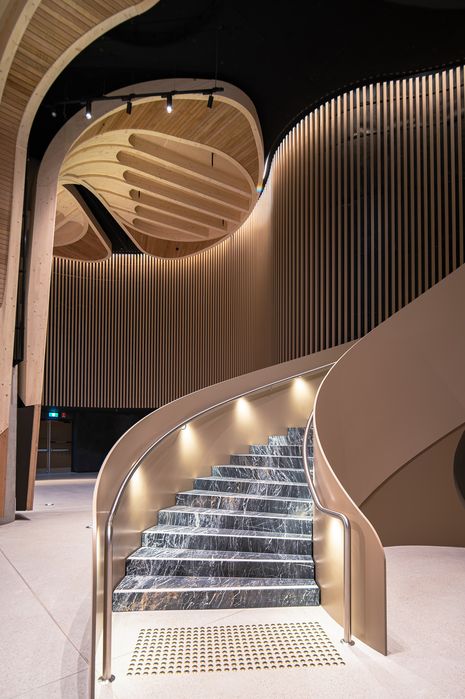 The venue includes both event and back-of-house spaces, including a main event hall, a pre-function space, gallery and exhibition rooms, a ticketing office, a commercial kitchen, green rooms, dressing rooms and a multipurpose educational space. Pitcured: Feature stairs.