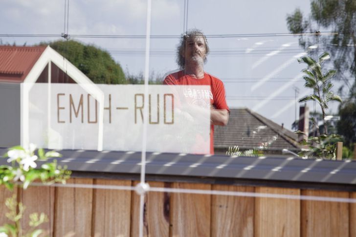 A sign saying "emoh-ruo" sits in the window of Peter and Mum's residence.