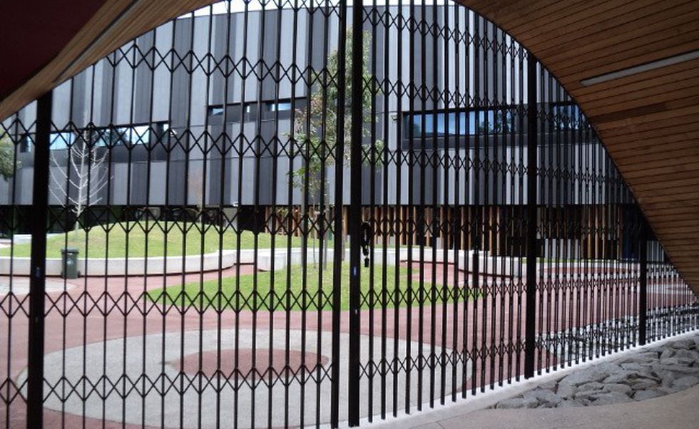 Curved concertina trellis security doors secure Infinity Centre