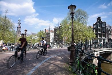 Street scene in an Amsterdam Channel. The Netherlands, Westerkerk in the background  by Jorge Royan, licensed under  CC BY-SA 3.0 