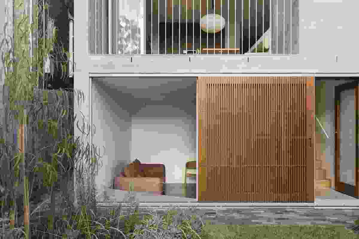 The lower-ground lounge is partially sunken and connects to the garden through large timber screens.