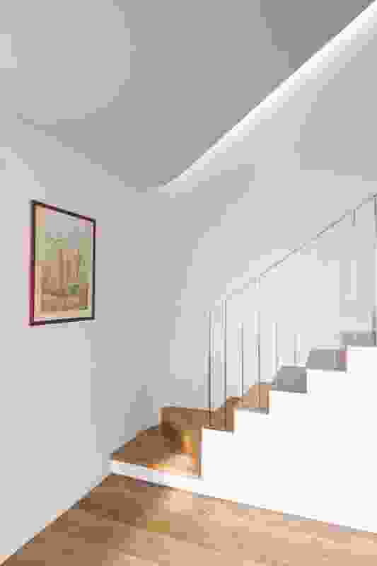 The stair in House 1 sweeps around the back of the living space and leads up to a library.
