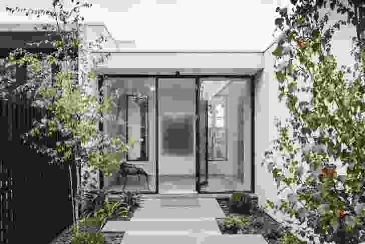 The addition enfolds a courtyard, establishing links between inside and out.