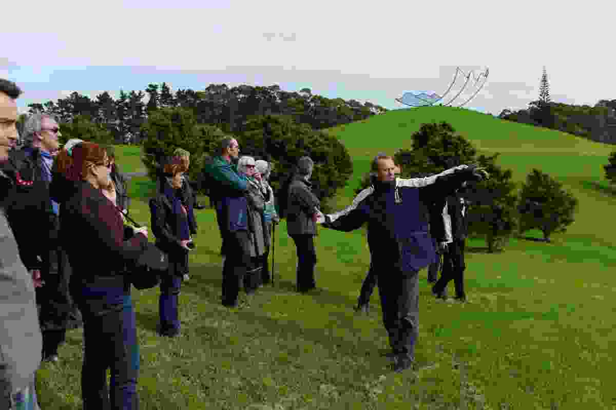 The author explains the lie of the land during a NZILA Auckland Branch visit to Gibbs Farm. On yonder hill is Neil Dawson’s 'Horizons' (1994).