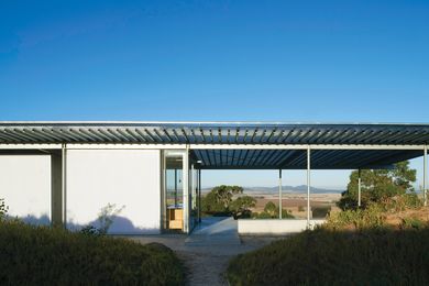 The translucent parasol roof unites the structural elements and salutes the archetypal hayshed.