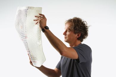 Yves Béhar inspects the back of the SAYL chair.