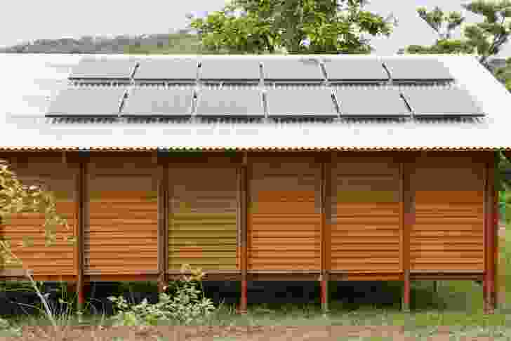 The Nev House, designed by Ken McBryde, is characterized by a high-pitched roof with large overhangs and louvred walls.