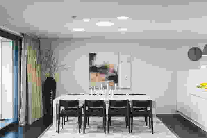The dining room table was designed by Catherine Huckerby to echo the negative detail around the doors in the apartment. 