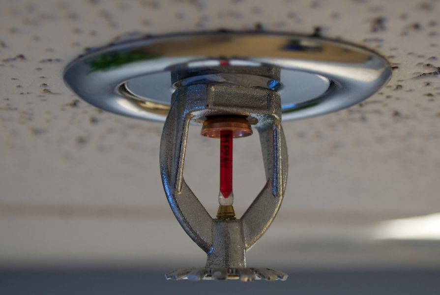 Fire sprinkler mounted on a roof  by Brandon Leon, licensed under CC BY-SA 2.0
