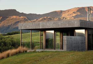 On the inside and out, a combination of Corten steel, shuttered concrete and schist in the home gives a rustic look that merges nicely with the landscape.