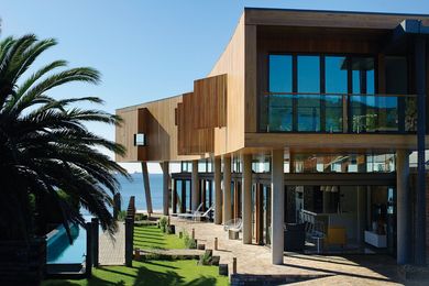 An elongated timber box perched on concrete columns.