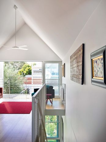 A voluminous first-floor room can be used for sewing, reading or choir practice. Artworks (L–R): Two Bob Tjungurrayi, Margaret Valentine.