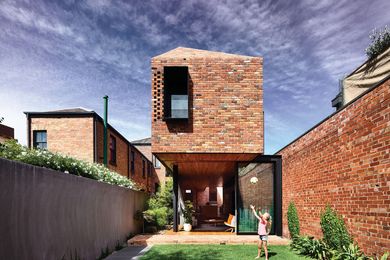 The red bricks of the extension angle up to become a roof, giving cohesion and simplicity to the built form.