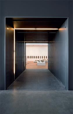 The thick zinc walls that form the entries to the galleries also provide storage areas for artworks.