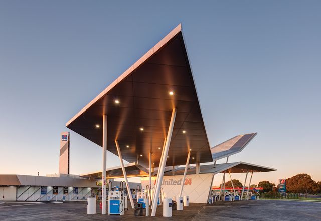 Sandwiched between an older-style petrol station and a furniture store, the building is a sculptural marvel in an otherwise featureless road.
