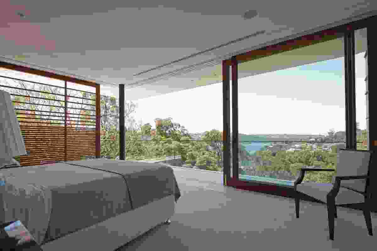 Large sliding doors with recycled blackbutt frames give the impression of a bedroom in the treetops.