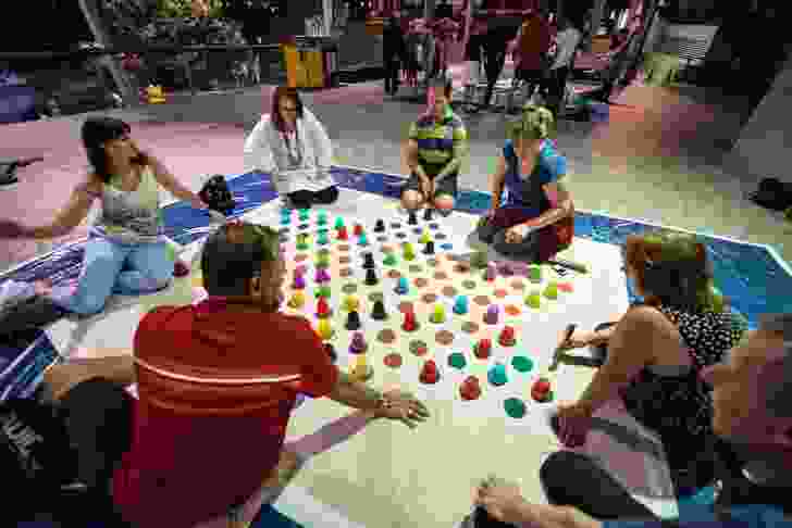 A giant game of chinese checkers gets underway. A giant mahjong game can be seen in the background.