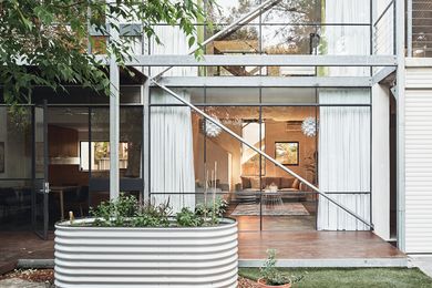 Hidden behind a heritage cottage, the house presents a dramatic glass facade to the north-facing courtyard.