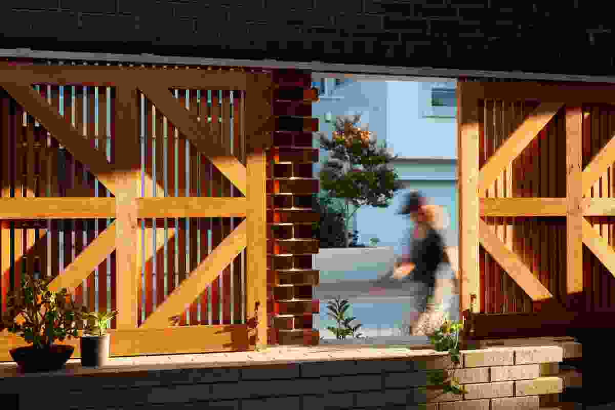 Timber shutters at the building’s edge allow residents to control the visual connection between the courtyard and the street.