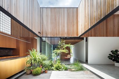 The central courtyard, lined with a landscaped garden, frames the sky and forms a pivot point around which daily life revolves.