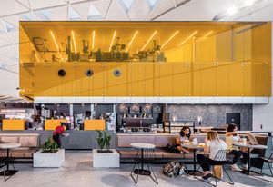 The commercial kitchen is visible through the glass walls of the kitchen, allowing customers to see the food production and delivery.