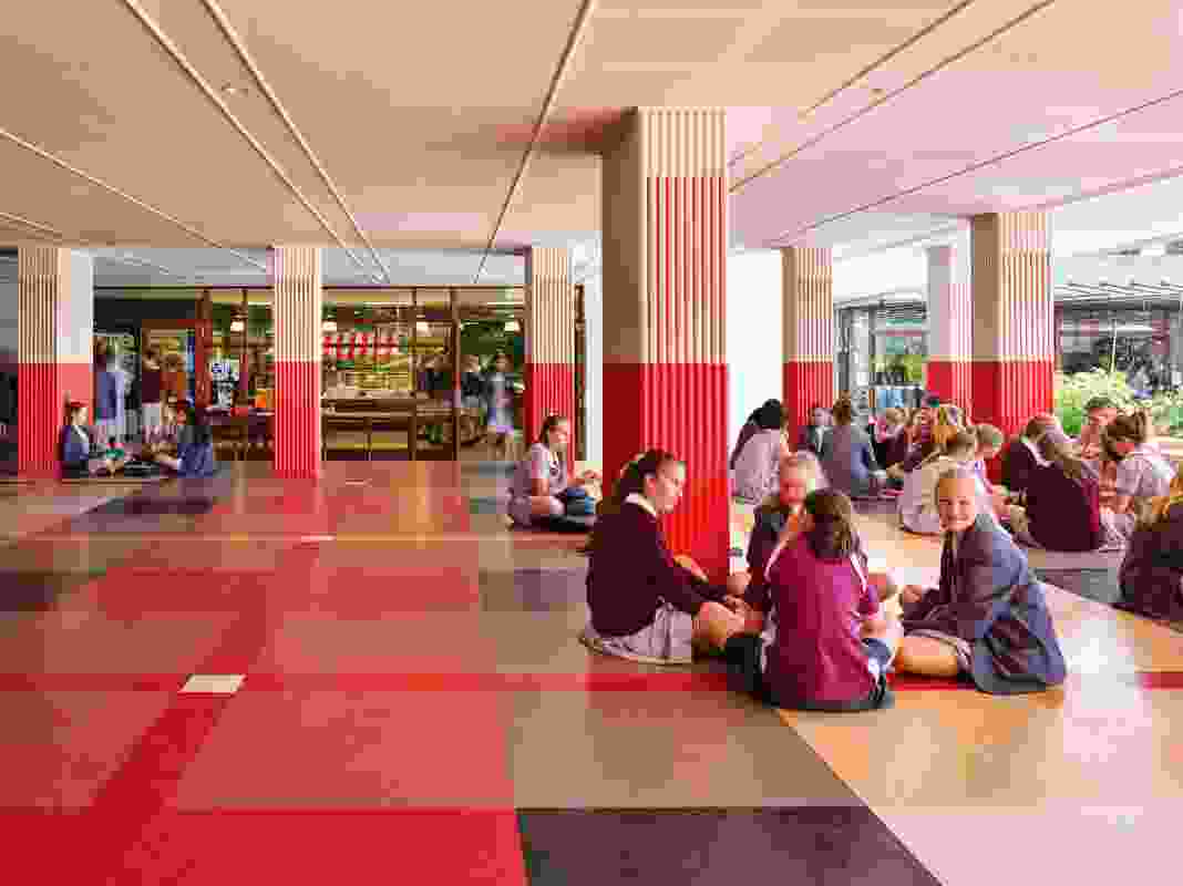 Adjacent to the canteen is a social space for students to eat and talk, designed as a raised platform that is colourfully patterned like a giant picnic rug.