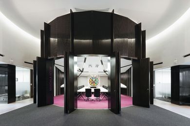 A bulging wall of tall, black columns surrounds the Mandala Room.