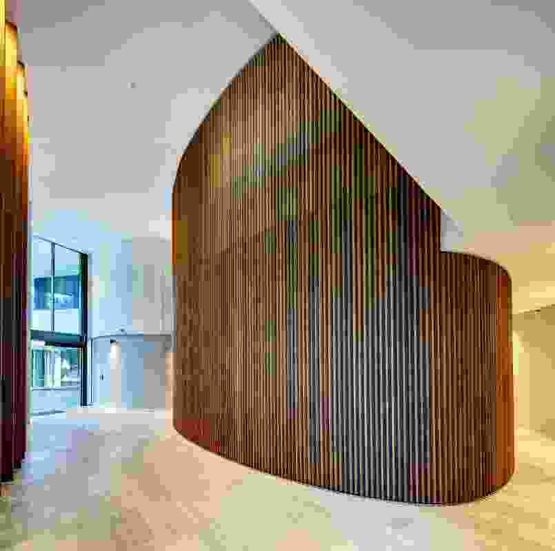 The elliptical form of the towers is echoed within the interior of the podium in the form of curved timber mullion screens encasing the lift cores.