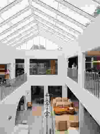 A central atrium brings natural light and ventilation deep into the plan.