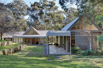 Timber trusses and slender steel columns on a concrete slab, give Hambrett House the unadorned presence of a shed or barn.