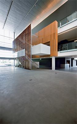 The entry foyer, with main stair up to the galleries. The main entry is to the left, with the “black box” spaces containing the cinemateque beyond.