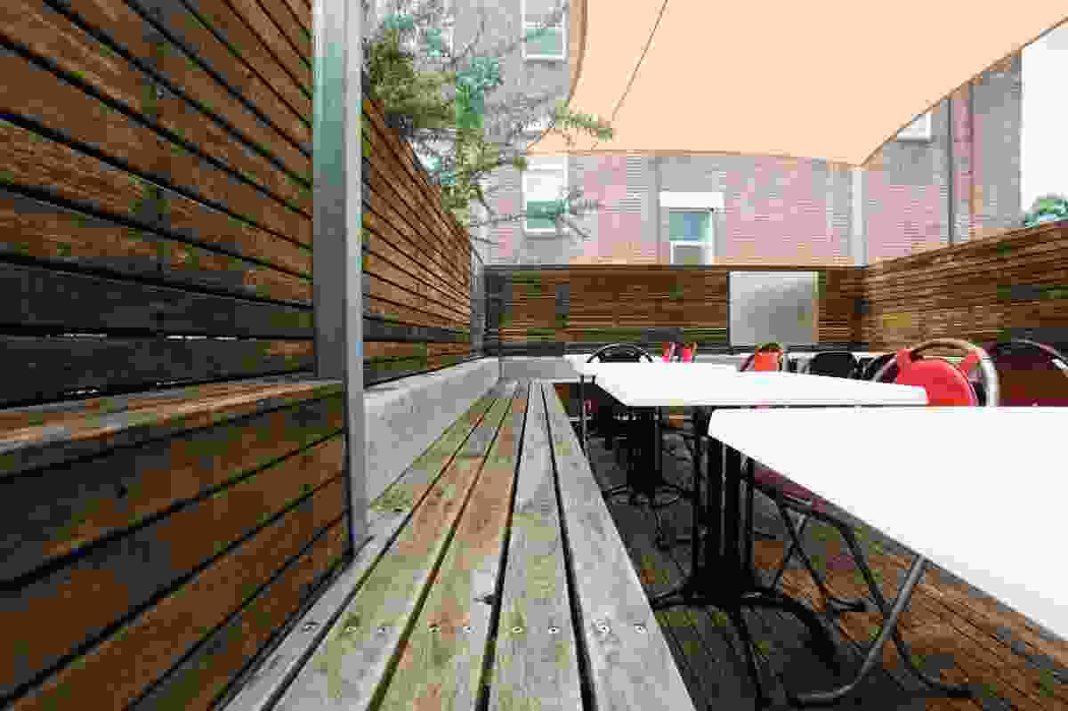 The outdoor deck dining features reclaimed timber benches.