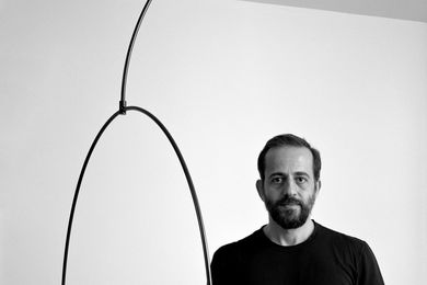 Michael Anastassiades with the Mobile Chandelier 9 for Flos. Photograph: Hélène Binet.