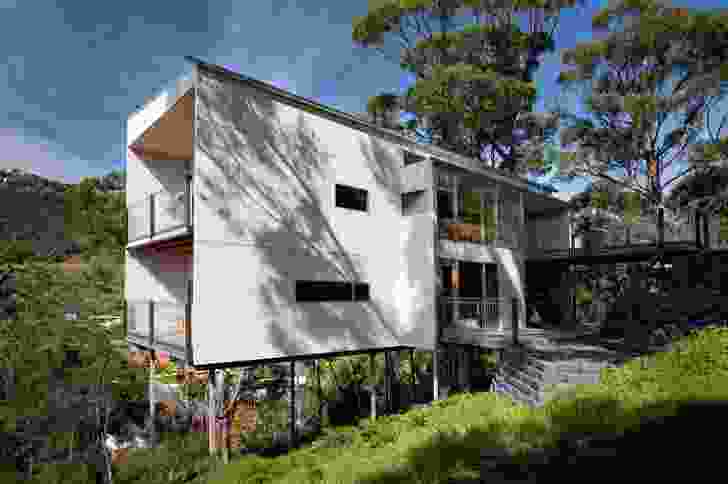 A regular grid of unpainted cement sheets forms the external shell of House 14A. The steepness of the site means that each house has a minimal footprint.