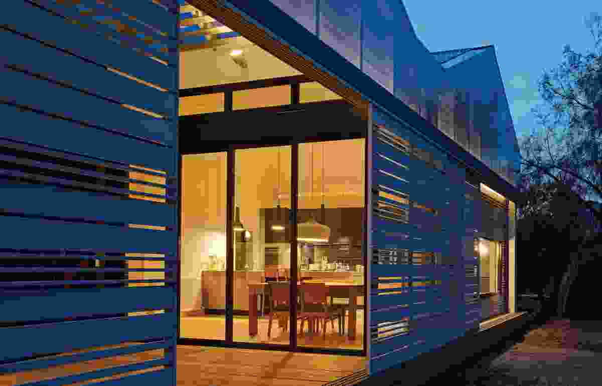 The timber screens give the rear elevation a sculptural play of light.
