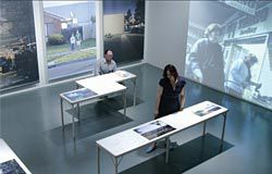 View of the
pavilion’s lower level,
showing the finely
crafted fold-out tables,
large thematic
photographs and
thematic video loop.
