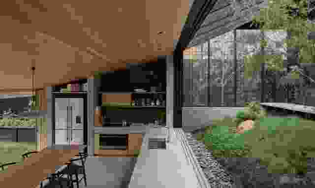 The kitchen and dining area can be opened on two sides to garden and courtyard.