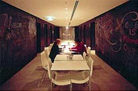 Interior views showing the range of finishings and furnishings used across the differently themed floors.Lift lobby with “graffiti” black board wall.