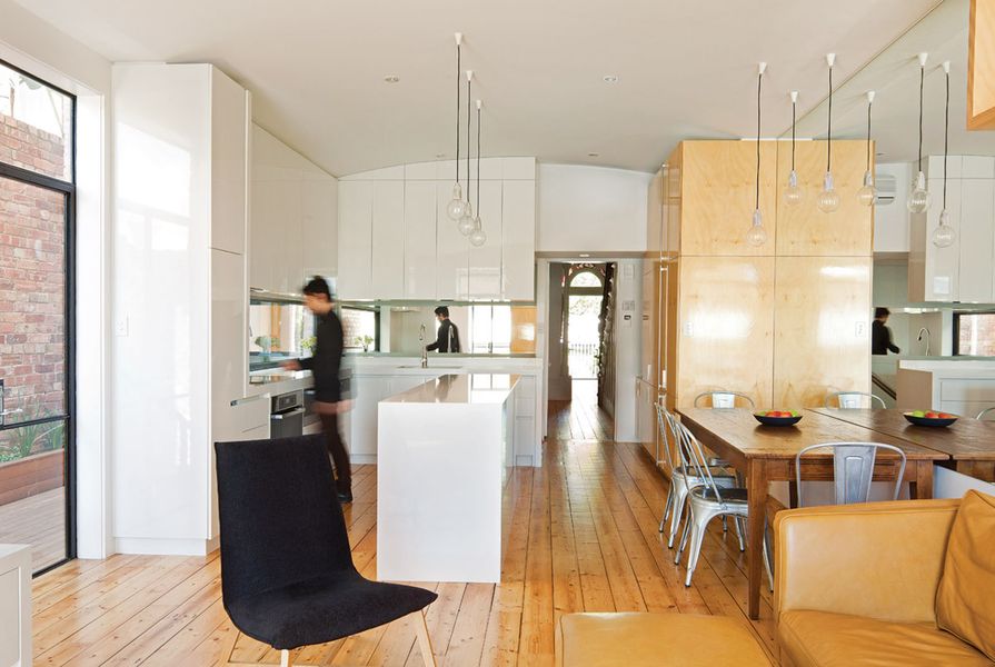 A marriage of opposites: the kitchen's white gloss and hoop pine joinery.