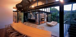 From the dining table, looking across the deck,
with Caroline Casey’s Zella day bed, to the living room
and the cliff path behind.Photograph Anthony Browell