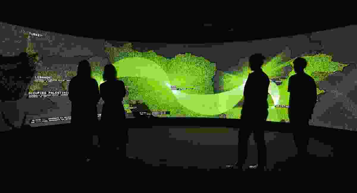 Exit comprises a room-high cylindrical screen, showing sequences of information organized into topics such as urbanization, migration, remittances, greenhouse gas emissions, sea-level rise and loss of indigenous cultures.