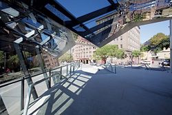 Looking out from under the canopy, across the urban landform of the podium, which “sets up the user for a spritely two-step with gravity.”