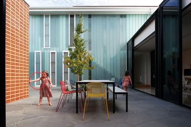 A central courtyard joins the old and new parts of the house and forms a primary activity zone for the family.