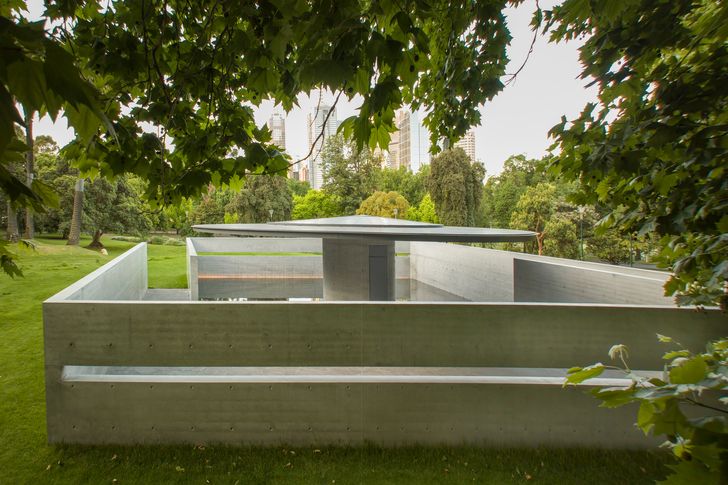 A 14.4 meter wide aluminum canopy partially shades the interior of the MPavilion designed by Tadao Ando.